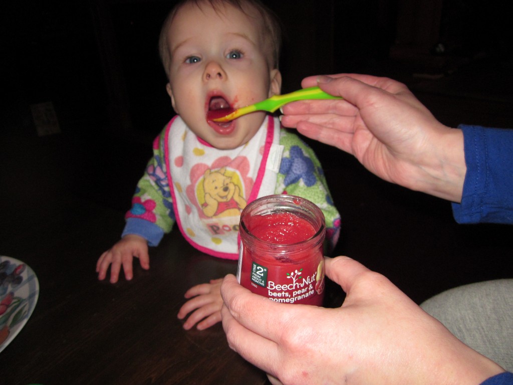 My daughter eating Beech-nut beets, pears, and pomegranate